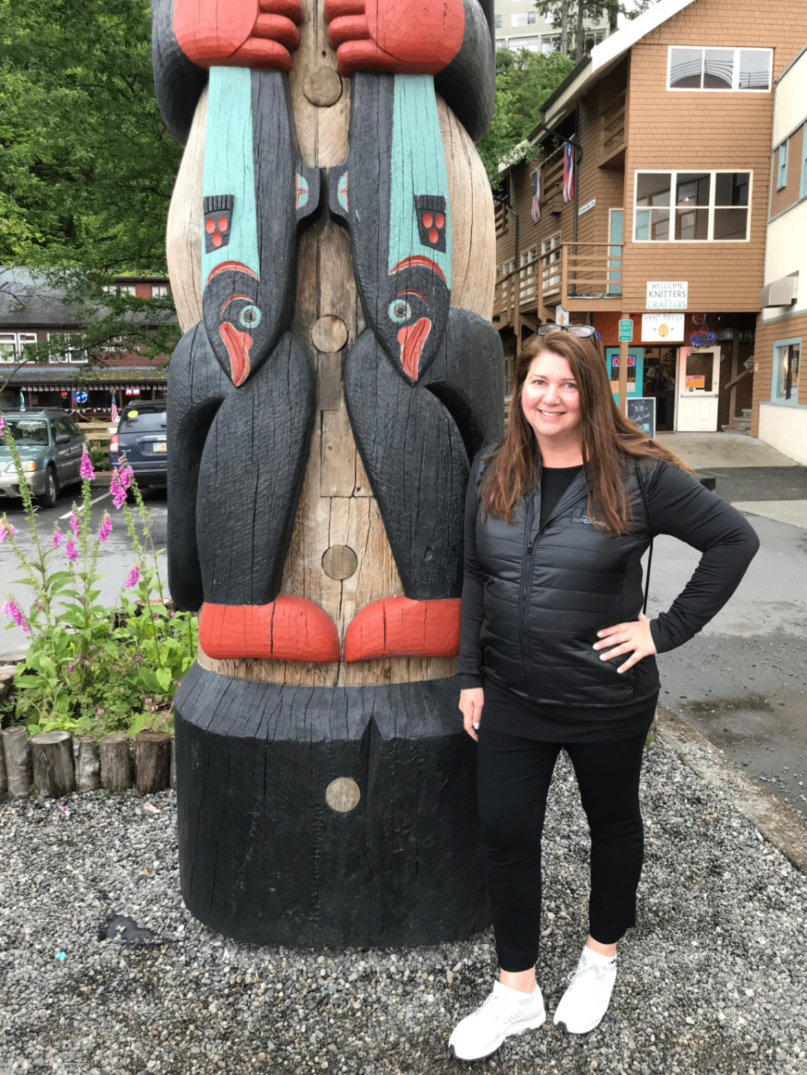 Sandra beside a totem pole in Alaska during a Disney Alaska cruise