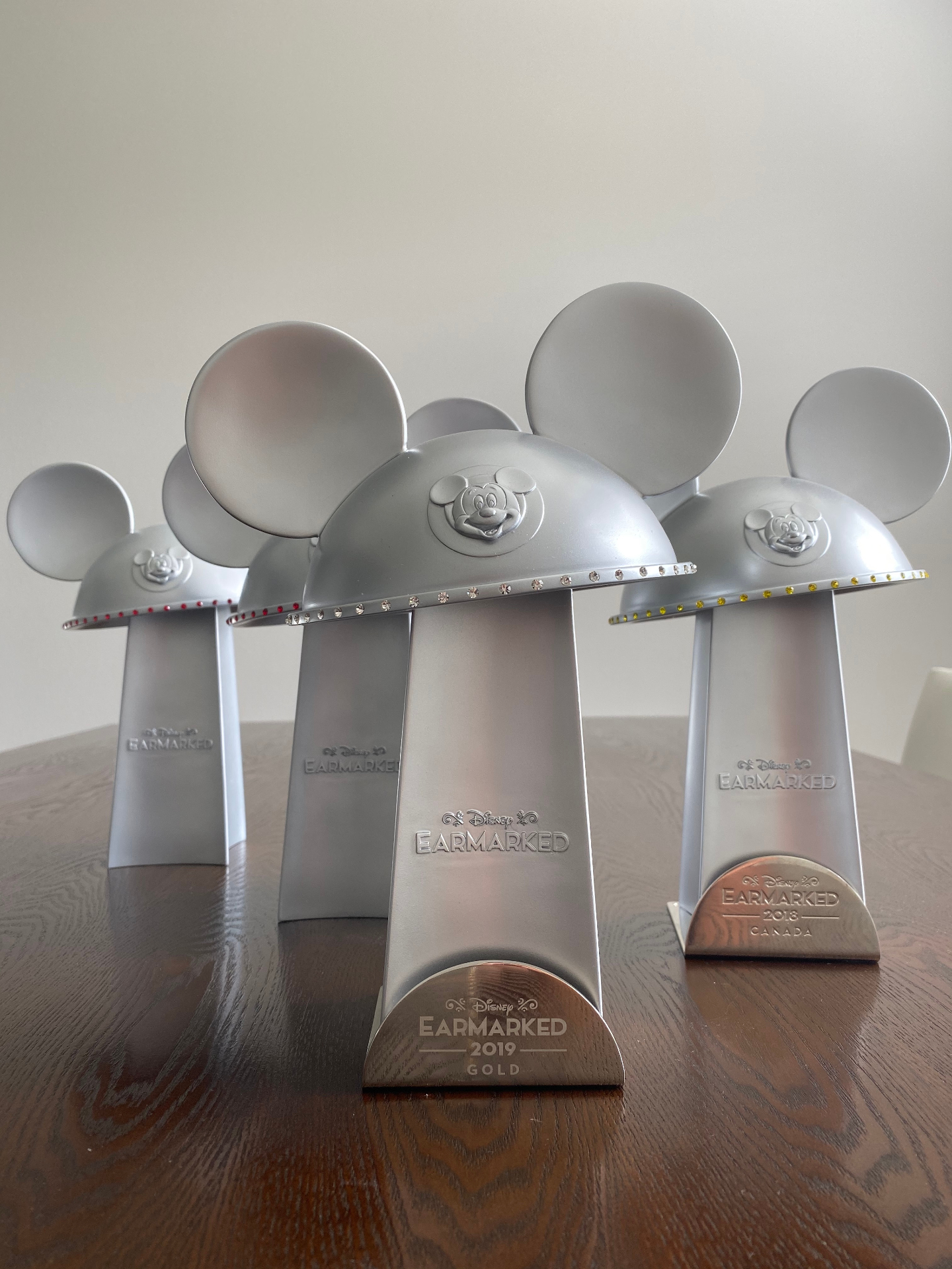 Disney Earmarked Mickey ear hat trophies including 2019 Gold and 2018 awards